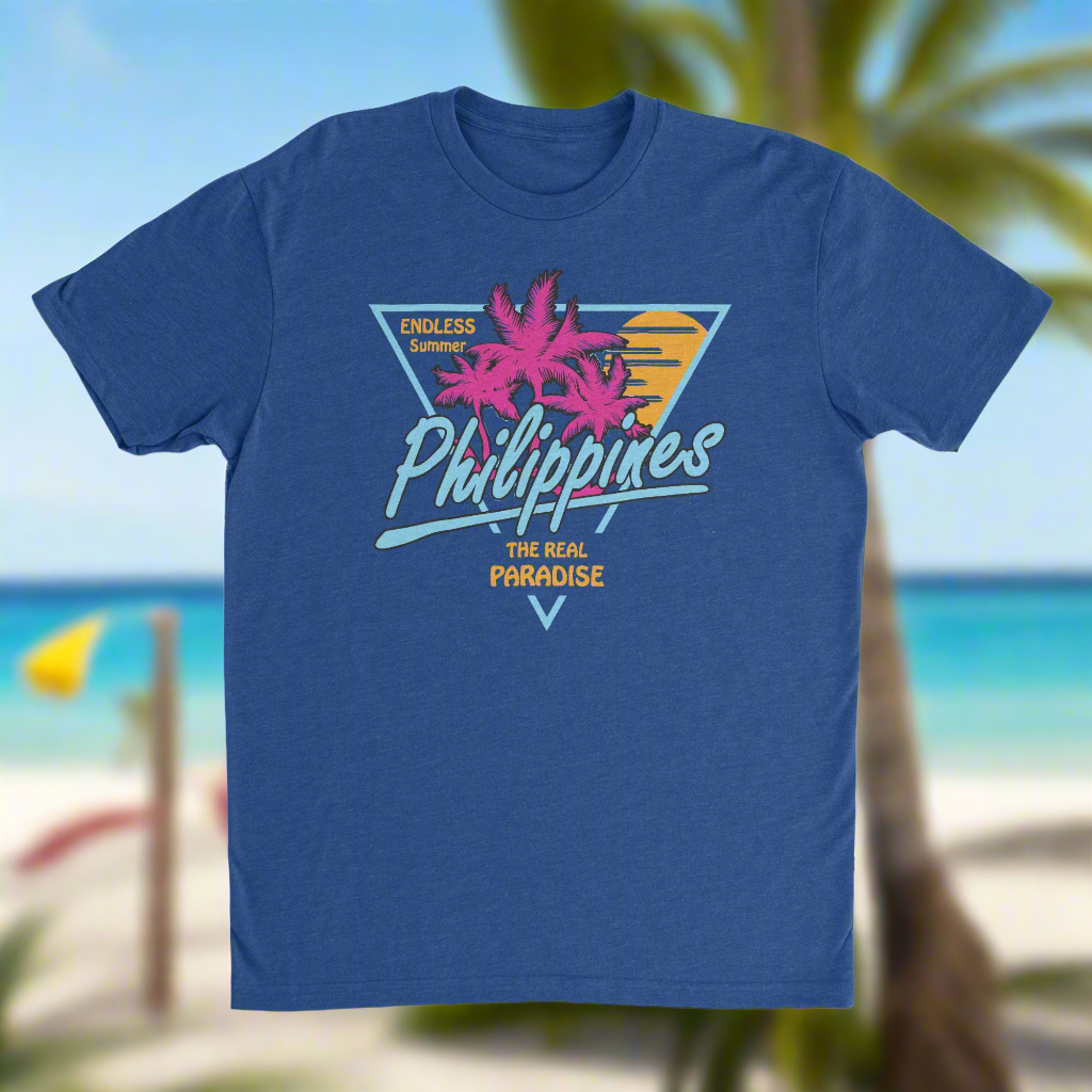 A blue t-shirt with a graphic print of pink flowers and text 'Philippines Paradise'.