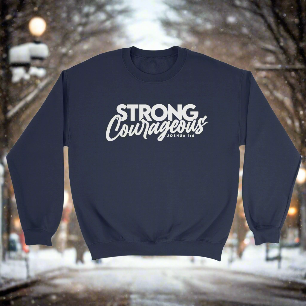 A navy WikaWear brand crewneck sweater with the text 'STRONG COURAGEOUS' printed on the front.