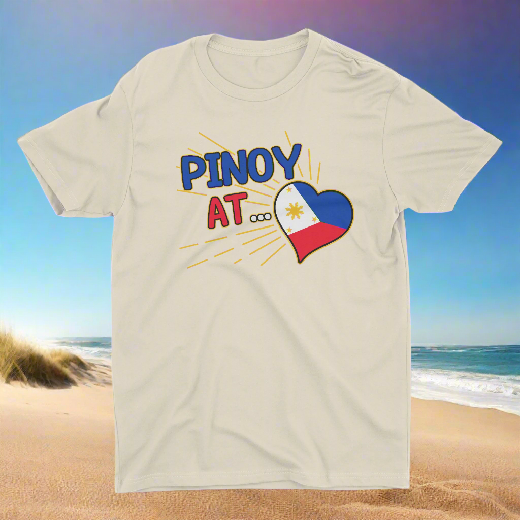 A beige t-shirt with the text 'PINOY AT ____' and a heart shape filled with the colors of the Philippine flag.