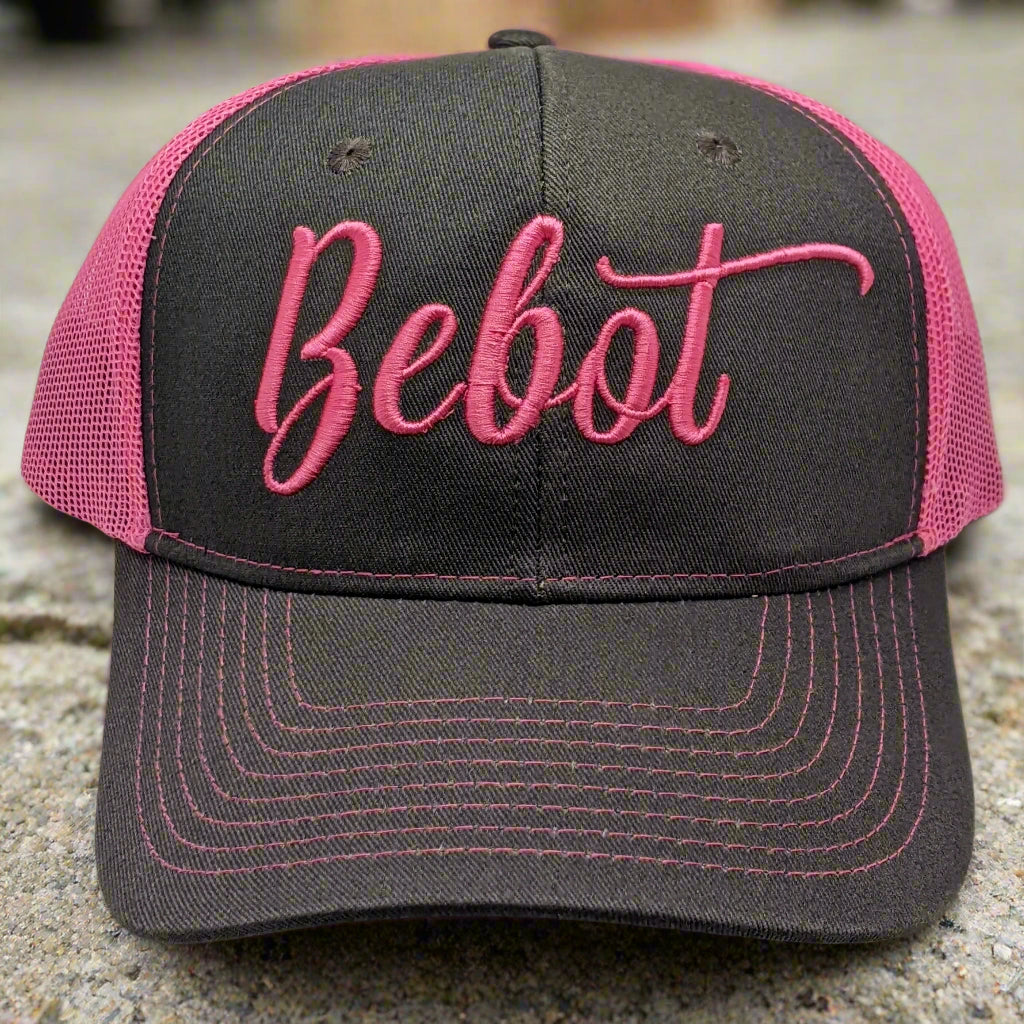 A gray and pink two-toned trucker cap with 'Bebot' written on the front in pink script.