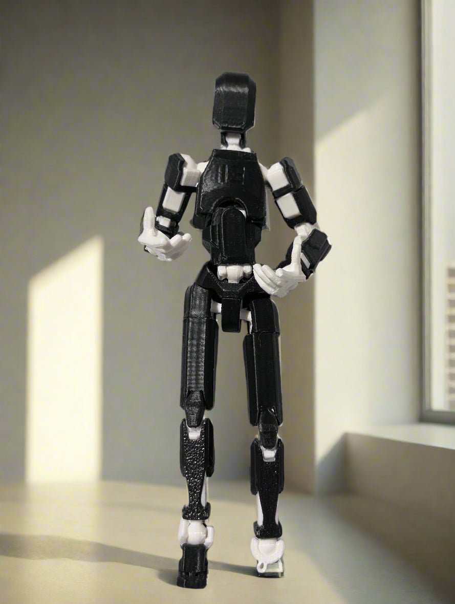 Black and white robot toy figure on a gray background