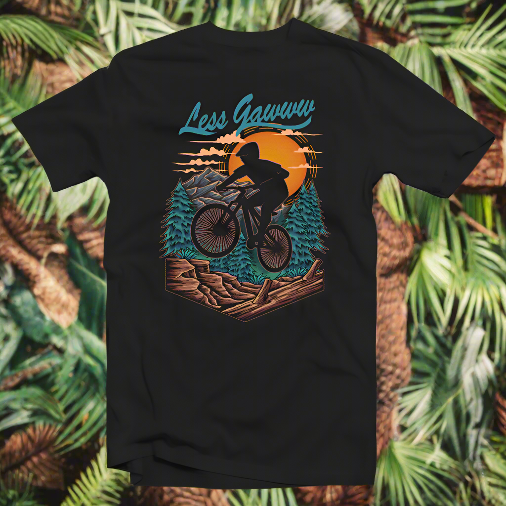 A black t-shirt with a graphic print of a person mountain biking in a sunset setting, with the text 'Less Gawwww' and 'Mountain biking'.