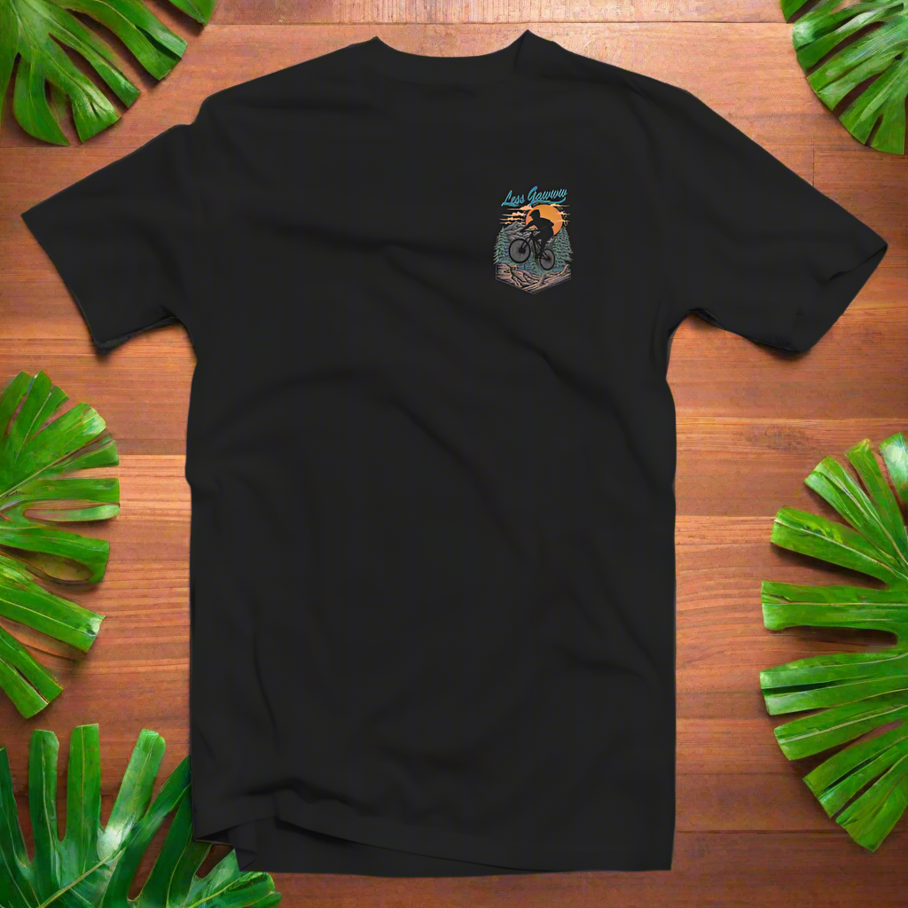 A black t-shirt with a patch on the front showing a stylized graphic of a bicycle and mountains.