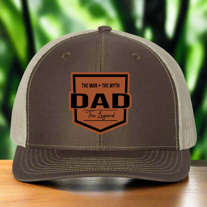 Brown and beige cap with 'DAD' text design on a white background
