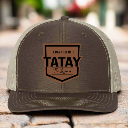 Brown and beige cap with 'TATAY' text on a white background