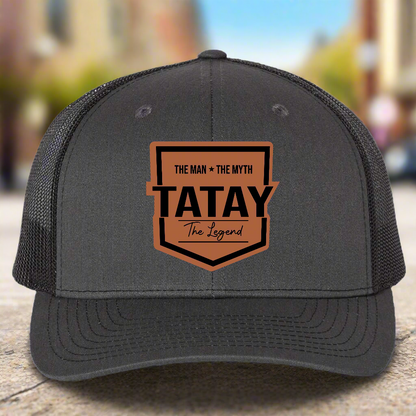 Gray trucker cap with 'TATAY' logo on a white background