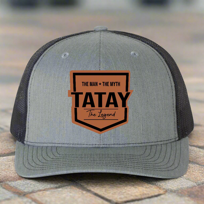 Gray and black cap with 'TATAY' logo on a white background
