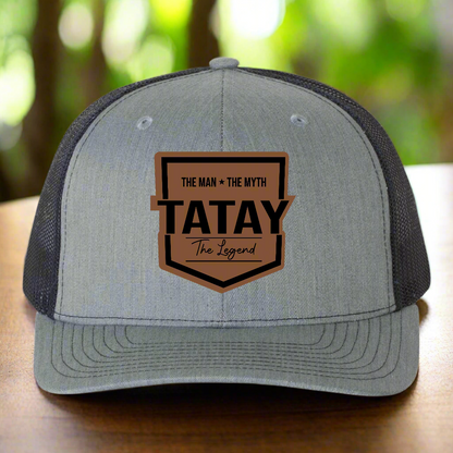 Gray and black cap with 'TATAY' logo on a white background
