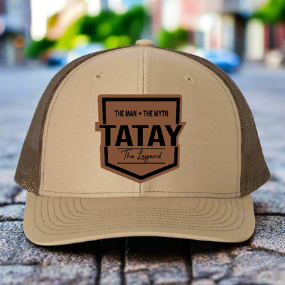 Beige and brown trucker hat with 'TATAY' logo on a white background