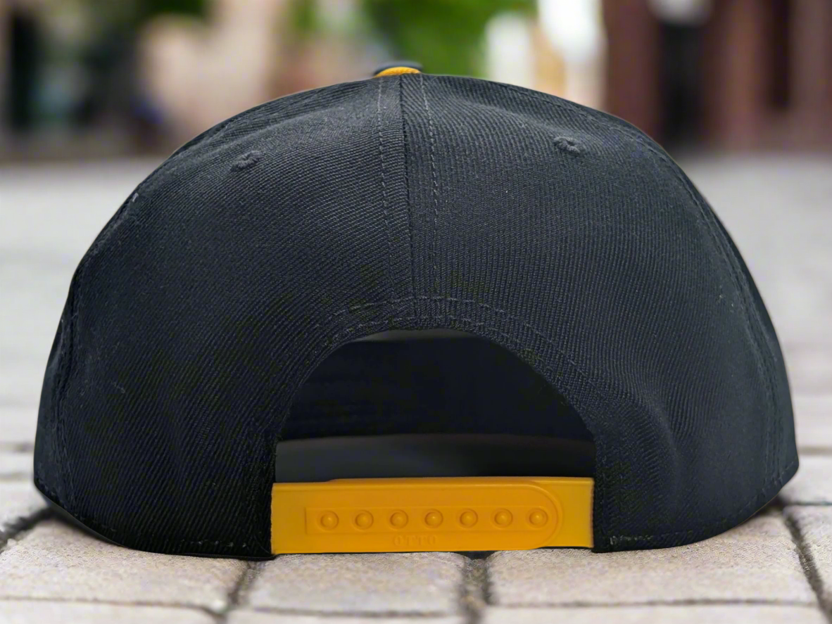 Black cap with yellow strap on a white background