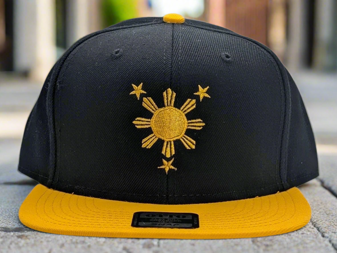 Black and yellow cap with a sun and star emblem on a white background